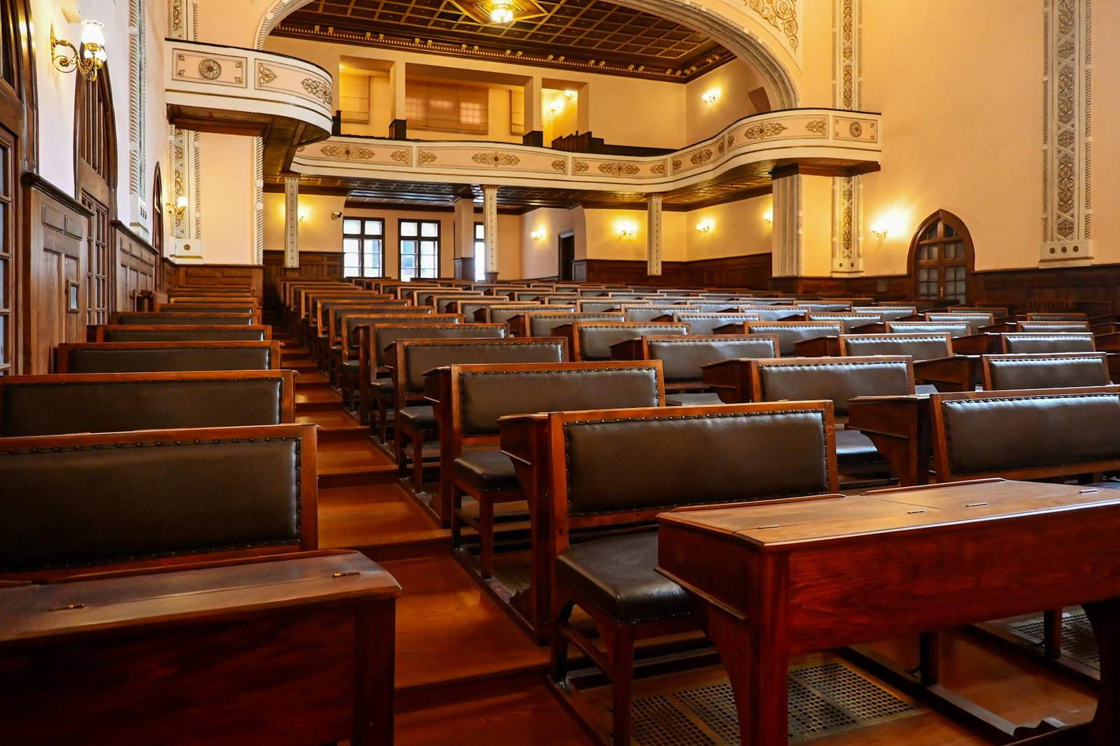 Historic lecture hall with wooden benches representing classical education